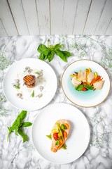 delicious dinner of salmon steak, grilled beef medallions and chicken fillet with vegetables