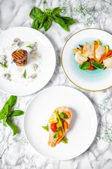 delicious dinner of salmon steak, grilled beef medallions and chicken fillet with vegetables