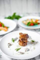 grilled beef medallions with mushrooms in white sauce