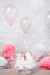 first birthday background - beautiful cake with one candle and balloons over white wall
