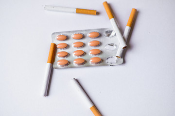 Cigarettes and Medicine on a table. Smoking causes cancer and emphysema. Health Care concept.