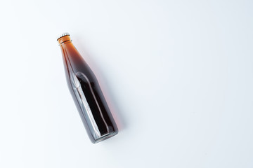 glass bottle with drink on white background