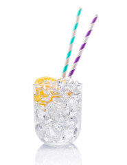 Ice water with lemon and straws in the glass isolated on a white background