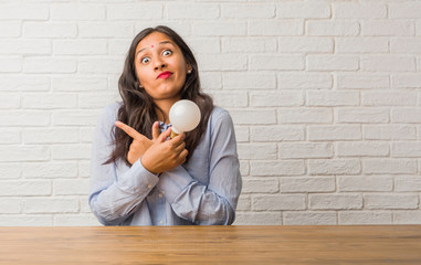 Young indian woman confused and doubtful, decide between two options, concept of indecision....