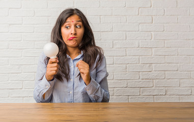 Young indian woman worried and overwhelmed, forgetful, realize something, expression of shock at...