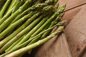 green asparagus on old board