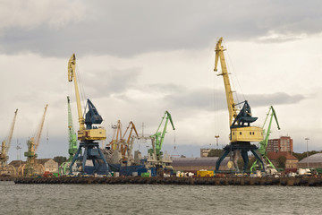 Fototapeta na wymiar Heavy harbor jib cranes in the Klaipeda Sea Port, Lithuania.