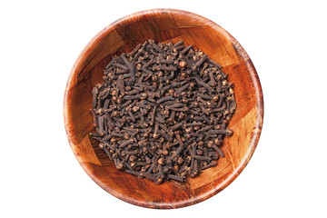 Cloves in brown wooden bowl isolated on white empty copy space. 