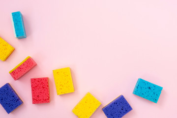 Some colorful sponges lying on pink background