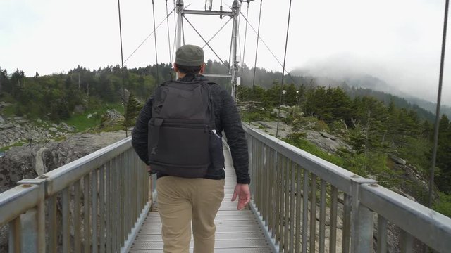 172 Hanging metallic bridge hiker male walking slow mo