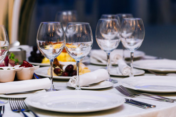 Beautifull glasses on table light white background. Party with red and white wine and holiday celebration concept.