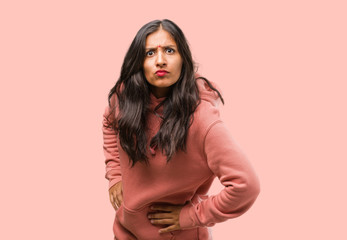 Portrait of fitness young indian woman very angry and upset, very tense, screaming furious,...