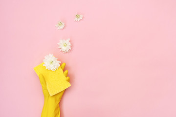 Woman holding sponge for washing with white flowers in her hands