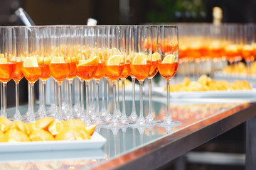 Beautifull Champagne glasses on light white background with orange. Party and holiday celebration concept