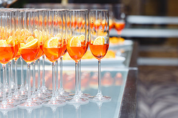 Beautifull Champagne glasses on light white background with orange. Party and holiday celebration concept