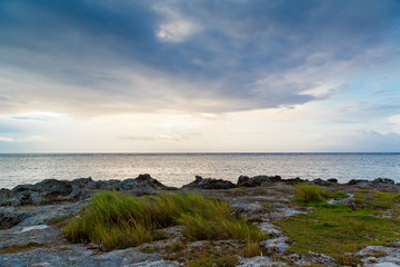 Fototapeta na wymiar Sea tropical landscape in cloudy weather at sunset.