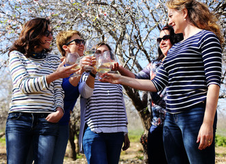 smiling real mature women is holding champagne glasses