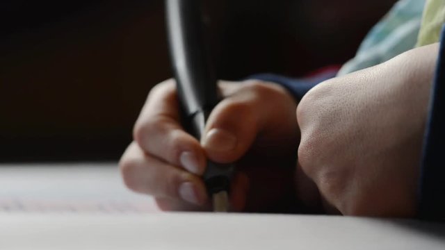 Hand with pen writing on a paper
