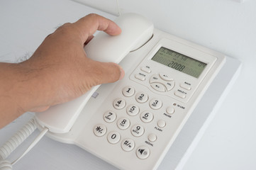 A man holding telephone receiver.
