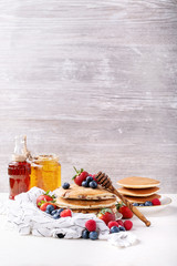 Blueberry pancakes served with honey