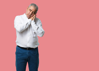 Middle aged man tired and very sleepy, looking comfortable and relaxed, sleep gesture