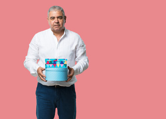 Middle aged man cheerful and calm, holding some boxes in vintage style