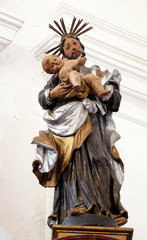 Fototapeta premium Statue of Saint Joseph with baby Jesus on the Saint Anthony altar in the church of Saint Leonard of Noblac in Kotari, Croatia