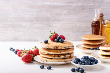 Blueberry pancakes served with honey