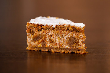 A piece of chocolate cake with mint on the table, close-up