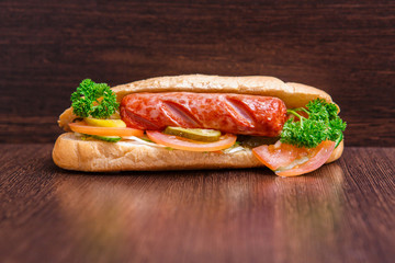 Tasty grilled prawn and beef burger with lettuce and mayonnaise served on pieces of brown paper on a rustic wooden table of counter, with copyspace