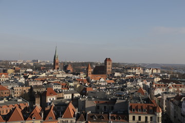 A view from the tower of the town hall in Torun. Visible Gothic buildings of the Old Town, New Town with the church of St. James, tenement houses, roofs covered with tiles. UNESCO heritage.