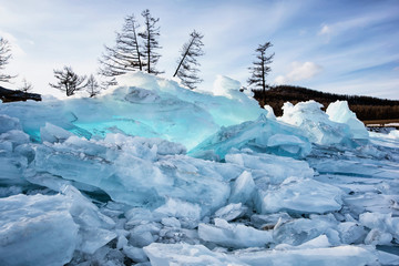 Pure transparent ice hummocks of frozen lake in winter
