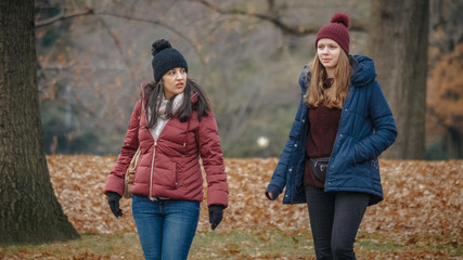 Two girls enjoy the nature and silence at Central Park New York