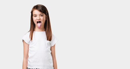 Full body little girl expression of confidence and emotion, fun and friendly, showing tongue as a...
