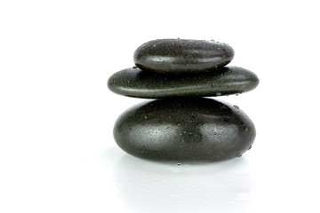 Stack of black pebbles on white background