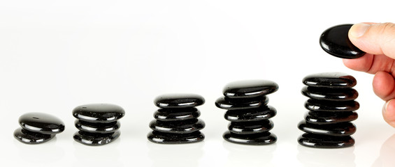 Four piles of pebbles on white background
