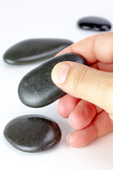 Black pebbles on white background. Concept of business or positive concept