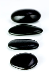 Black Stones aligned on a white background