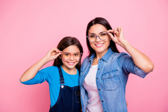 Portrait of two nice trendy cute winsome pretty lovely attractive charming cheerful cheery positive straight-haired girls touching glasses lifestyle isolated over pink pastel background