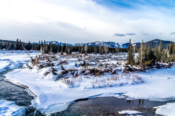 Water poking through the ice in early spring, Deer Lake Provincial Recreation Area, Alberta, Canada