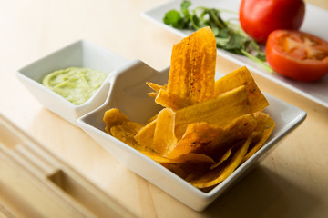 Banana chips with guacamole. Spanish Tapas.