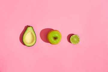 half Avocado fruits apple on pink background