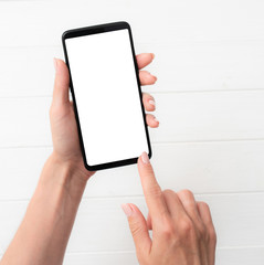 User holding modern smartphone with white screen in hand