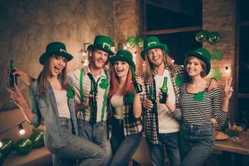 Best friends company in traditional national culture irish leprechaun costumes holding hands arms...