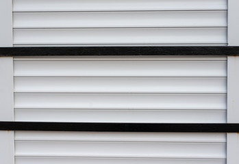 Fototapeta premium Parallel horizontal metal blinds with two black bars across