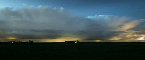 Panorama of autumn thunderstorms along the dutch coast.  Thundery showers with beautiful anvils in...