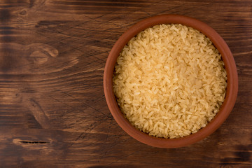 Fototapeta na wymiar white rice in bowl on wooden table background