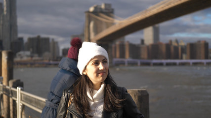 Two friends in New York take a walk at Brooklyn Bridge