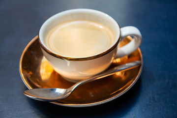 white cup of hot coffee on table