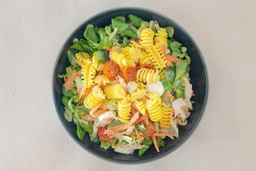 Salad made from radiatori cooked pasta, goat cheese and oil vinaigrette